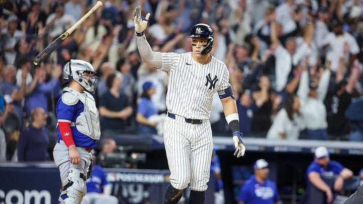 Oct 7, 2025; Bronx, New York, USA; New York Yankees outfielder Aaron Judge (99) flips his bat after hitting a three-run home run in the fourth inning against the Toronto Blue Jays during game three of the ALDS round for the 2025 MLB playoffs at Yankee Stadium. Mandatory Credit: Wendell Cruz-Imagn Images