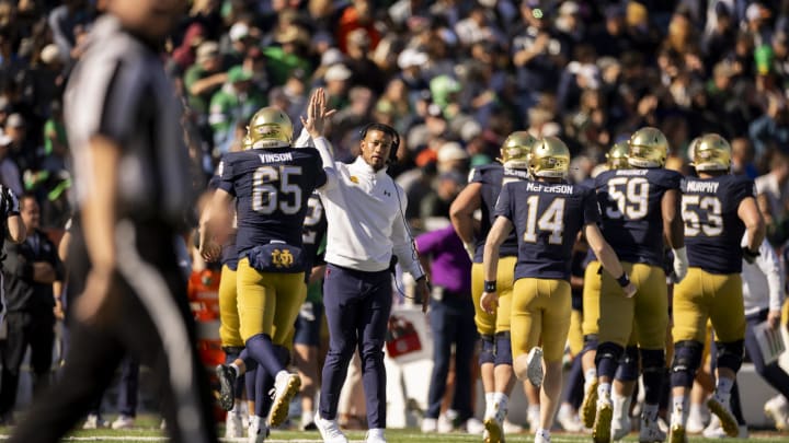 Dec 29, 2023; El Paso, TX, USA; Notre Dame football head coach Marcus Freeman greeted his players after a touchdown against the Oregon State Beavers in the Sun Bowl at Sun Bowl Stadium. Mandatory Credit: Ivan Pierre Aguirre-USA TODAY Sports