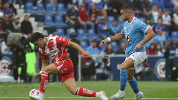 Willer Ditta #4 of Cruz Azul and José Paradela #10 of Club...
