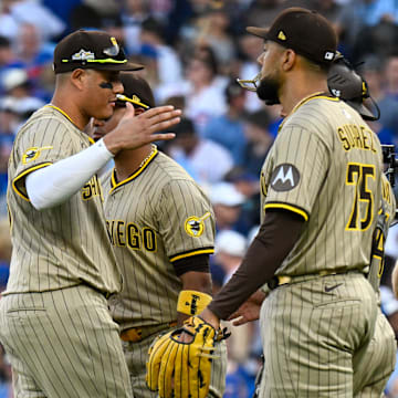 Oct 1, 2025; Chicago, Illinois, USA; San Diego Padres relief pitcher Robert Suarez (75) celebrates with teammates after the final out for the win against the Chicago Cubs in the ninth inning during game two of the Wildcard round for the 2025 MLB playoffs at Wrigley Field. Mandatory Credit: Matt Marton-Imagn Images