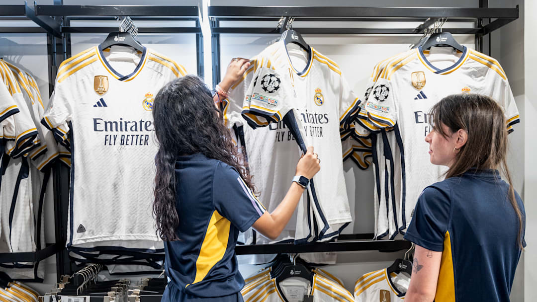 Workers organize and prepare Real Madrid football team shirt... Workers organize and prepare Real Madrid football team shirt...
