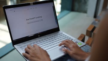 In this photo illustration, a woman browses OpenAi website...