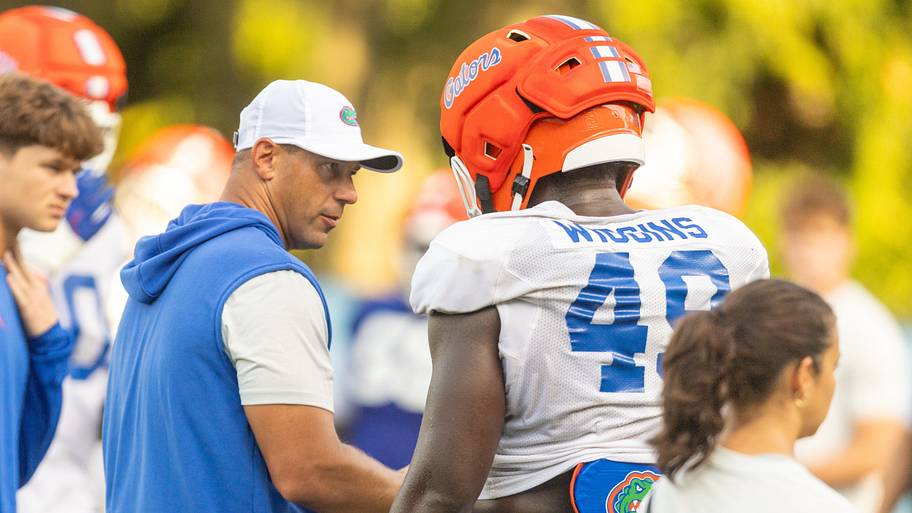Florida football head coach Jon Sumrall talks with defensive lineman Jalen Wiggins during a practice.