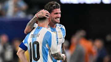 Argentina midfielder Rodrigo de Paul shares a laugh with teammate Lionel Messi during CONMEBOL Copa America USA in 2024.
