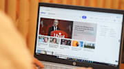 In this photo illustration, A woman browses yahoo website on...