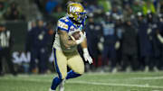 Nov 20, 2022; Regina, Saskatchewan, CAN;  Winnipeg Blue Bombers running back Brady Oliveira (20) runs against the Toronto Argonauts in the second half. The Argonauts defeated the Blue Bombers to win the 2022 Grey Cup Championship at Mosaic Stadium. Toronto won 24-23. Mandatory Credit: Bob Frid-Imagn Images