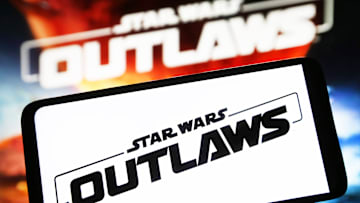 In this photo illustration, a Star Wars Outlaws logo of a...