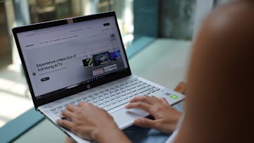 .In this photo illustration, a woman browses Samsung website...