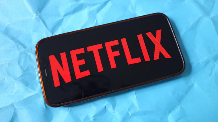 In this photo illustration, the Netflix company logo is seen...