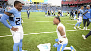 Los Angeles Chargers safety Derwin James Jr. signs his jersey for Tennessee Titans safety Quandre Diggs.