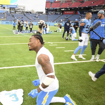 Los Angeles Chargers safety Derwin James Jr. signs his jersey for Tennessee Titans safety Quandre Diggs.