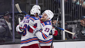 Nov 1, 2025; Seattle, Washington, USA;  New York Rangers defenseman Adam Fox (23) celebrates with New York Rangers center J.T. Miller (8) and New York Rangers left wing Will Cuylle (50) after an overtime win against the Seattle Kraken at Climate Pledge Arena. Mandatory Credit: Blake Dahlin-Imagn Images