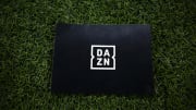 A placard bearing the logo of DAZN is seen on the pitch...