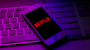 In this photo illustration a Netflix logo seen displayed on...