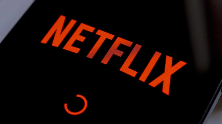 In this photo illustration, the Netflix streaming app logo...