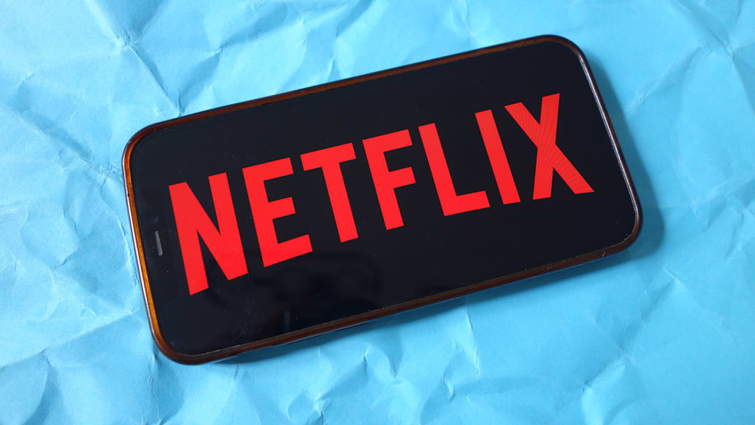 In this photo illustration, the Netflix company logo is seen...