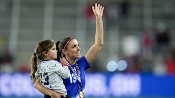 Alex Morgan waves with daughter Charlie after Canada v USWNT match