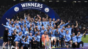 Players and staff of Manchester City FC celebrate with the...