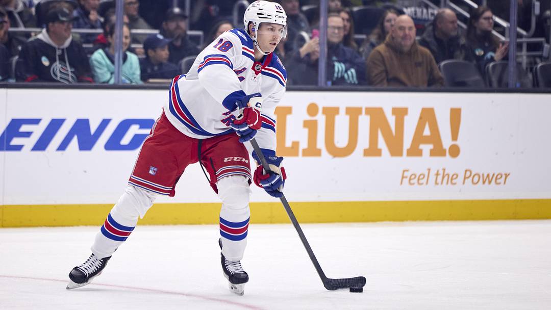 Nov 1, 2025; Seattle, Washington, USA; New York Rangers defenseman Urho Vaakanainen (18) passes the puck during the first period against the Seattle Kraken at Climate Pledge Arena. Mandatory Credit: Blake Dahlin-Imagn Images