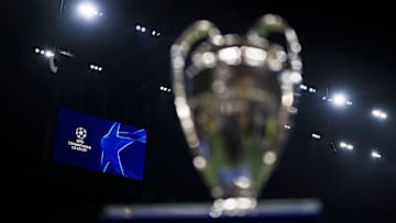 A scoreboard displays the logo of the UEFA Champions League...