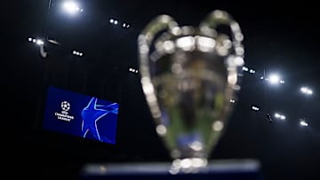 A scoreboard displays the logo of the UEFA Champions League...