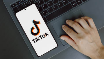 In this photo illustration, the TikTok logo is displayed on...