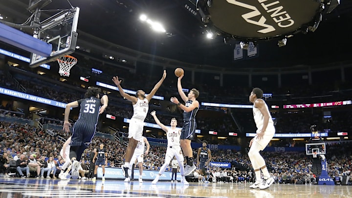 Feb 25, 2025; Orlando, Florida, USA; Orlando Magic forward Franz Wagner (22) takes a shot over Cleveland Cavaliers forward Evan Mobley (4) during the first half at Kia Center. Mandatory Credit: Russell Lansford-Imagn Images