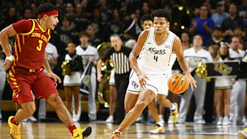 Feb 11, 2025; Orlando, Florida, USA;  Central Florida Knights center Keyshawn Hall (4) dribbles the ball up the court while Iowa State Cyclones guard Tamin Lipsey (3) attempts to defend at Addition Financial Arena. Mandatory Credit: Russell Lansford-Imagn Images