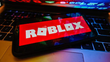 In this photo illustration a Roblox logo is displayed on a...