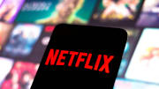 In this photo illustration, the Netflix logo seen displayed...