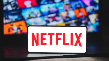 In this photo illustration, the Netflix logo is displayed on...