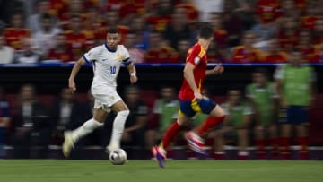 Kylian Mbappe (L) of France is challenged by Nacho Fernandez...