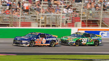 Sep 8, 2024; Hampton, Georgia, USA; NASCAR Cup Series driver Joey Logano (22) and NASCAR Cup Series driver Daniel Suarez (99) come around for the final laps at Atlanta Motor Speedway. Mandatory Credit: Jason Allen-Imagn Images