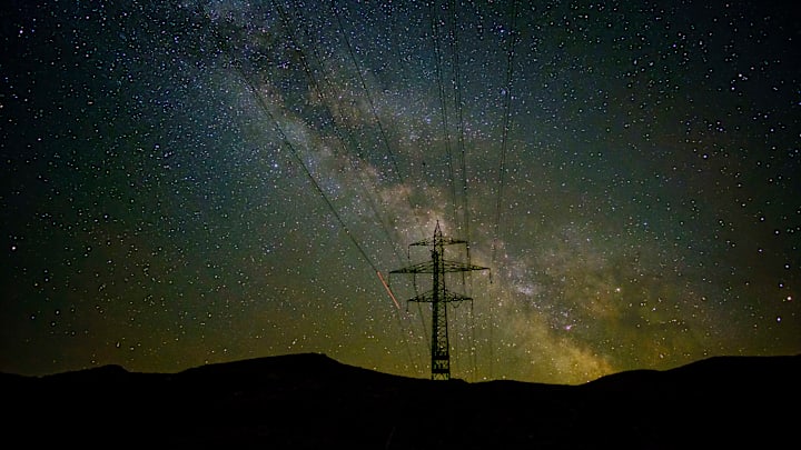 A electrical powerline in front of the Milky Way stars at... A electrical powerline in front of the Milky Way stars at...