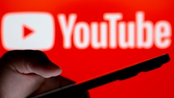 In this photo illustration, the YouTube logo seen in the...