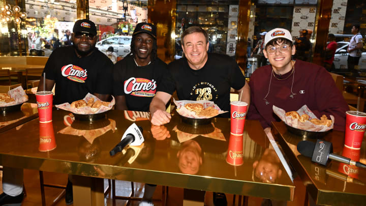 BOSTON, MASSACHUSETTS - AUGUST 28: David Ortiz, Jrue Holiday and Todd Graves attend the celebration of Raising Cane's "Golden Birthday" with opening of new gold restaurant on August 28, 2024 in Boston, Massachusetts. (Photo by Dave Kotinsky/Getty Images for Raising Cane's)