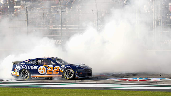 Sep 8, 2024; Hampton, Georgia, USA; NASCAR Cup Series driver Joey Logano (22) does a burnout at the finish line after winning at Atlanta Motor Speedway. Mandatory Credit: Jason Allen-Imagn Images