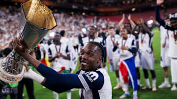 Mathys Tel of Tottenham Hotspur FC lifts the trophy during...