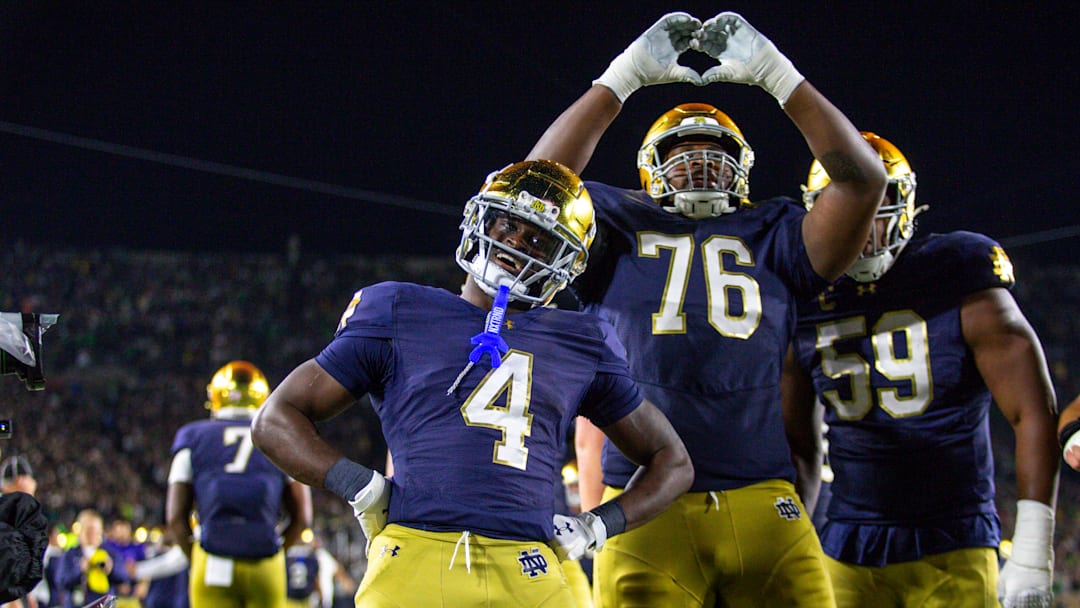 Jeremiyah Love #4 of the University of Notre Dame celebrates his touchdown with teammate Guerby Lambert #76 during a game between University of Southern California and University of Notre Dame at Notre Dame Stadium on October 18, 2025 in South Bend, Indiana.