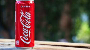 In this photo illustration a Coca-Cola can seen displayed on...
