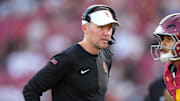 Aug 30, 2025; Los Angeles, California, USA; Southern California Trojans head coach Lincoln Riley talks with Southern California Trojans quarterback Husan Longstreet (4) in the second half against the Missouri State Bears at United Airlines Field at Los Angeles Memorial Coliseum. Mandatory Credit: Kirby Lee-Imagn Images