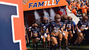 Oct 19, 2024; Champaign, Illinois, USA;  Illinois Fighting Illini players take the field before a game against the Michigan Wolverines at Memorial Stadium. Mandatory Credit: Ron Johnson-Imagn Images