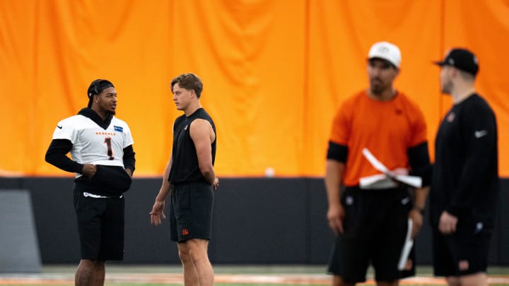 Cincinnati Bengals wide receiver Ja'Marr Chase (1) and Cincinnati Bengals quarterback Joe Burrow (9) talk at Bengals spring practice at the IEL Indoor Facility in Cincinnati on Thursday, June 13, 2024.