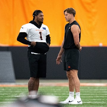 Cincinnati Bengals wide receiver Ja'Marr Chase (1) and Cincinnati Bengals quarterback Joe Burrow (9) talk at Bengals spring practice at the IEL Indoor Facility in Cincinnati on Thursday, June 13, 2024.