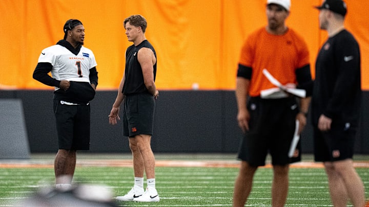 Cincinnati Bengals wide receiver Ja'Marr Chase (1) and Cincinnati Bengals quarterback Joe Burrow (9) talk at Bengals spring practice at the IEL Indoor Facility in Cincinnati on Thursday, June 13, 2024.