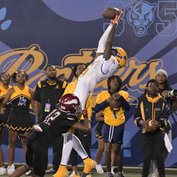 Miami Northwestern's Calvin Russell Jr. leaps for a tough catch attempt during the first half of the Class 3A state championship on Dec. 14, 2024.