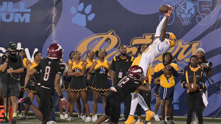 Miami Northwestern's Calvin Russell Jr. leaps for a tough catch attempt during the first half of the Class 3A state championship on Dec. 14, 2024.