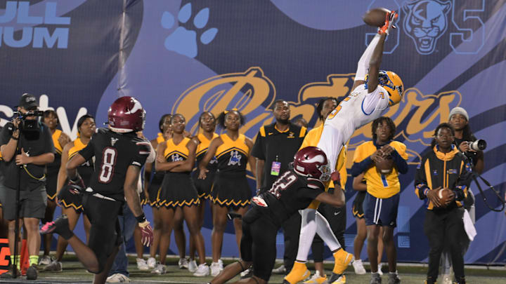 Miami Northwestern's Calvin Russell Jr. ranges high for a pass at the Florida State 3A Championship Game in December. His Bulls won 41-0.