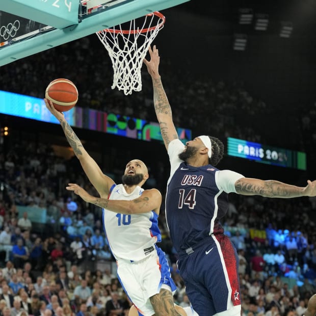 France shooting guard Evan Fournier (10) shoots vs. Team USA center Anthony Davis (14) in the men's basketball gold game.