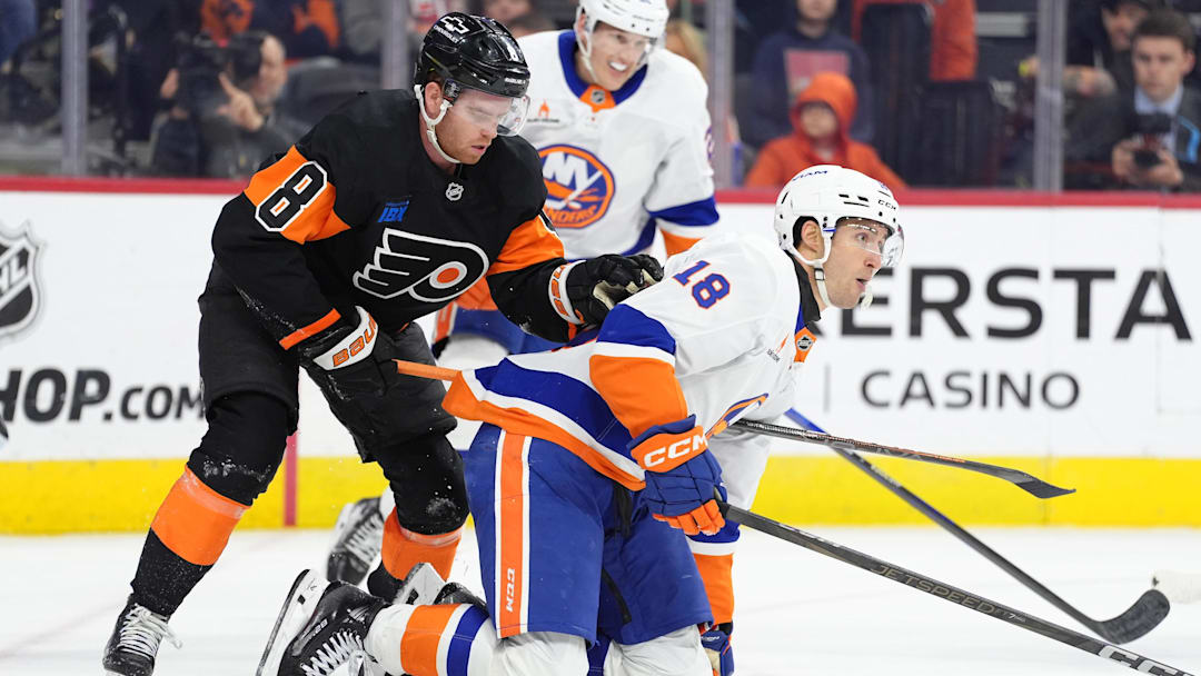 Apr 12, 2025; Philadelphia, Pennsylvania, USA; Philadelphia Flyers defenseman Cam York (8) attempts to free his stick against New York Islanders left wing Pierre Engvall (18) in the first period at Wells Fargo Center. Mandatory Credit: Kyle Ross-Imagn Images